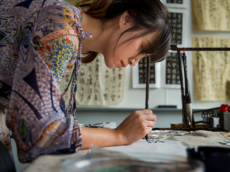 Tulane graduate student working on Chinese paintings
