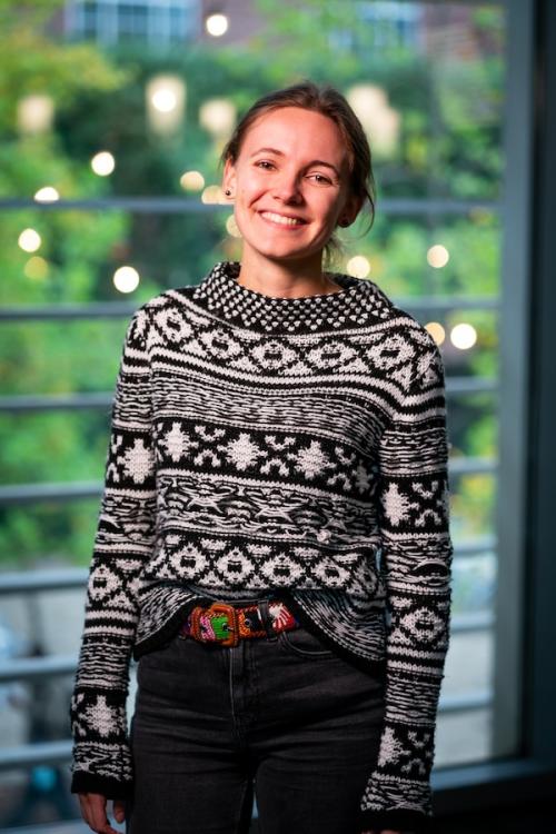 Women smiling in white and black patterned sweater