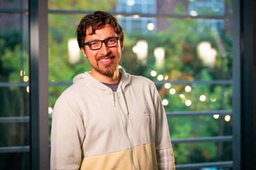 Man smiling in white sweater
